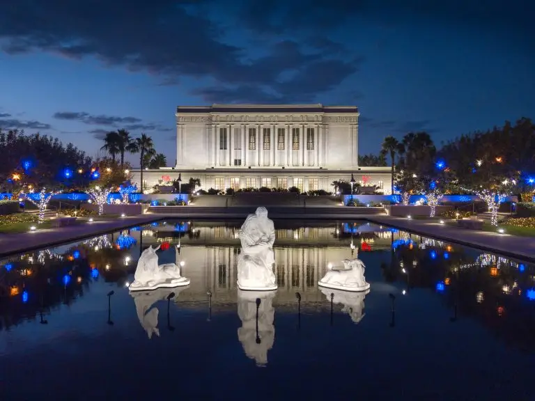 Christmas lights and statues around the reflection pool at the Mesa Temple Grounds at Christmas time.